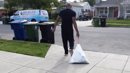 Man throwing away a bag of ...