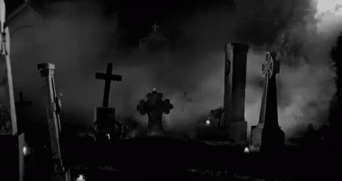 Cross Headstone At A Spooky Cemetery GIF