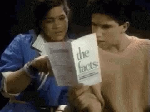 Two people nodding and reading a pamphlet titled "the f