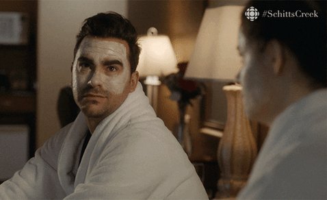 Dan Levy as David Rose in Schitt's Creek in a robe and face 