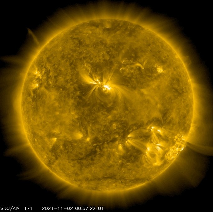 rotating sun with active loops of plasma glowing on its surf
