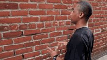 A man talking to a brick wall