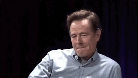 A gif of Bryan Cranston doing a mic drop