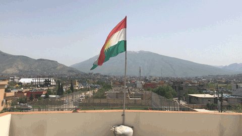 Flag of Kurdistan waves in ...