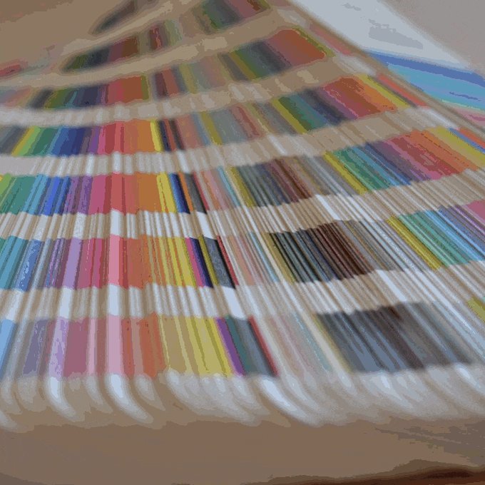 A Pantone swatchbook; it slowly fades to grey, then to black