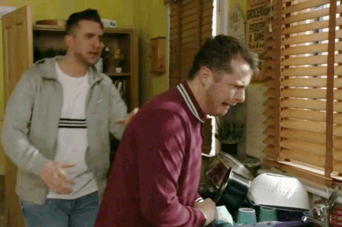 Gif from EastEnders. Callum running towards Ben, who is cryi