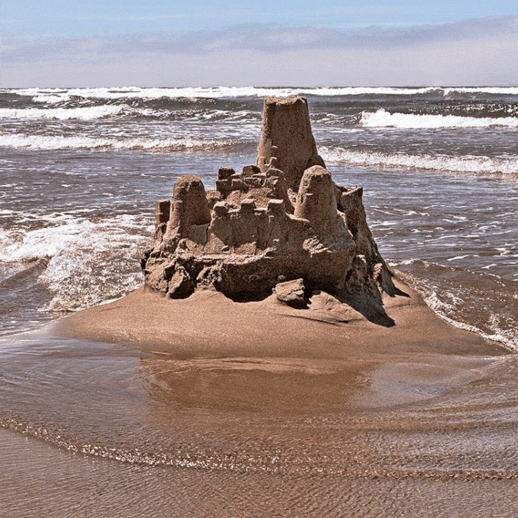 An animated gif of a sand-castle that is melting into the ri