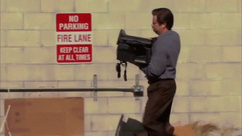 man throwing away a typewriter